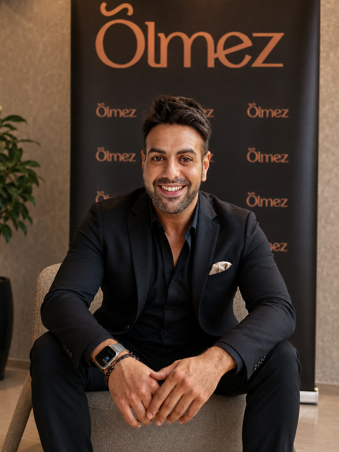 Founder seated in front of an Ölmez backdrop