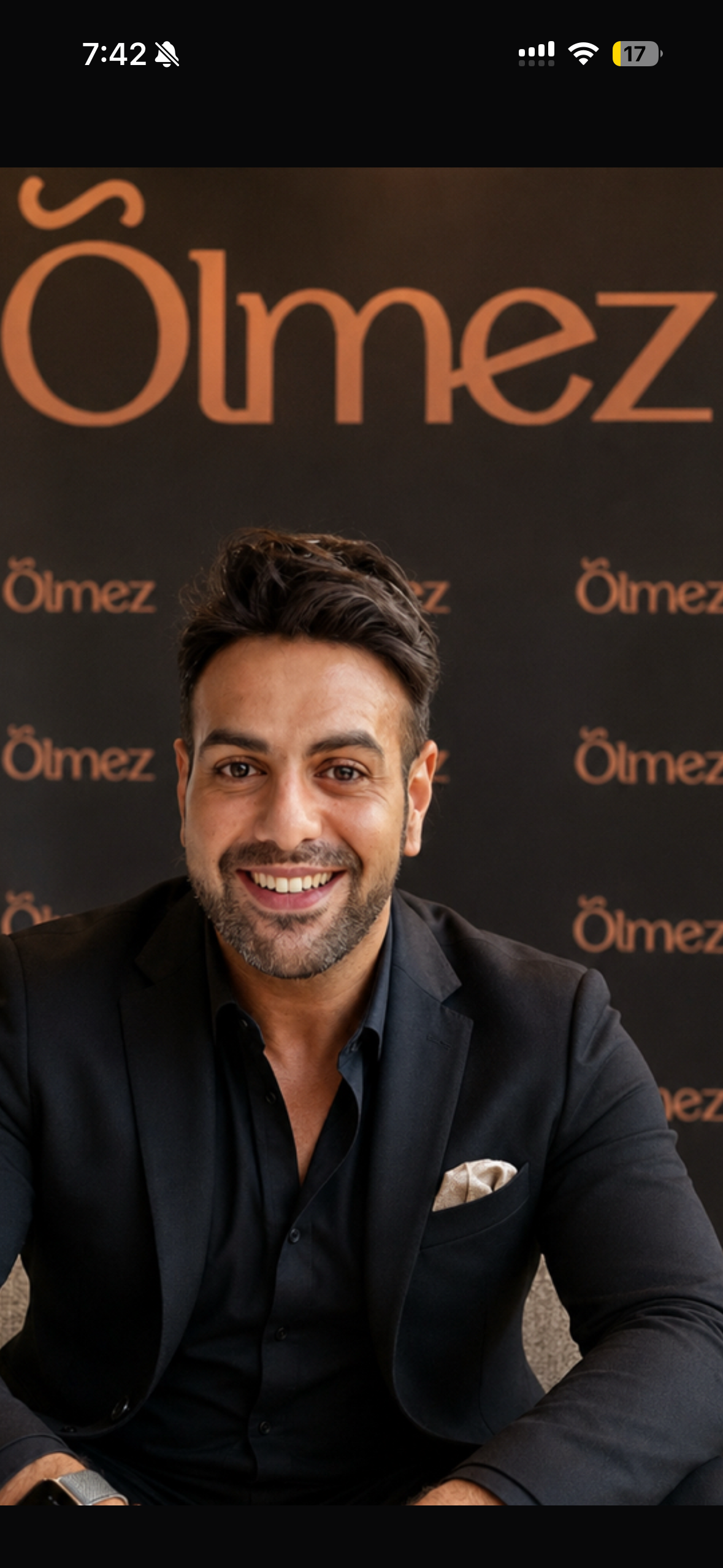 Stage presentation with the Ölmez brand projected behind the founder